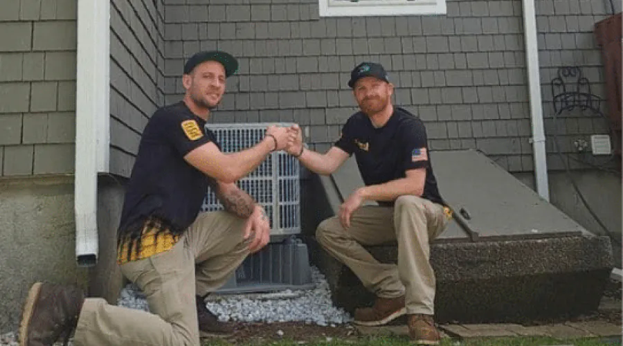 service techs helping one another complete job
